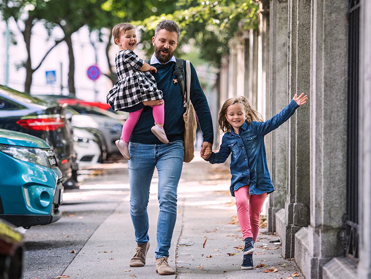 Dad walking with two daughters