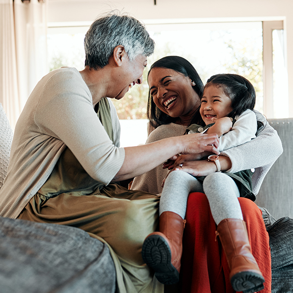 grandmother laughing with daughter and granddaughter