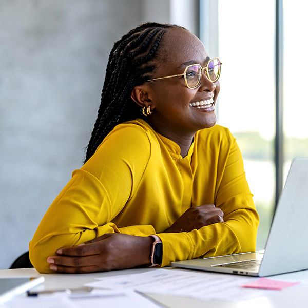 young adult smiling with computer