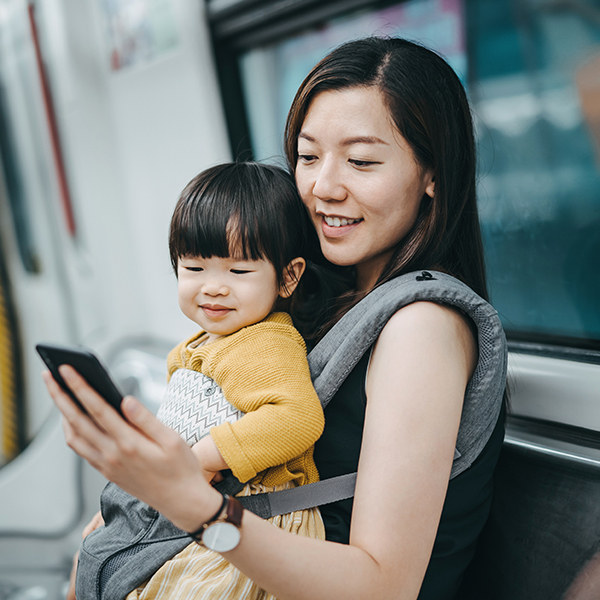 mother looking at phone with daughter