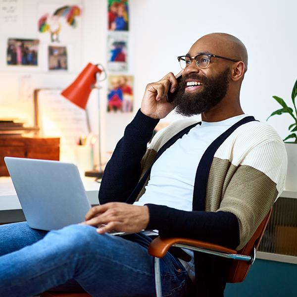 A man on the phone with a laptop