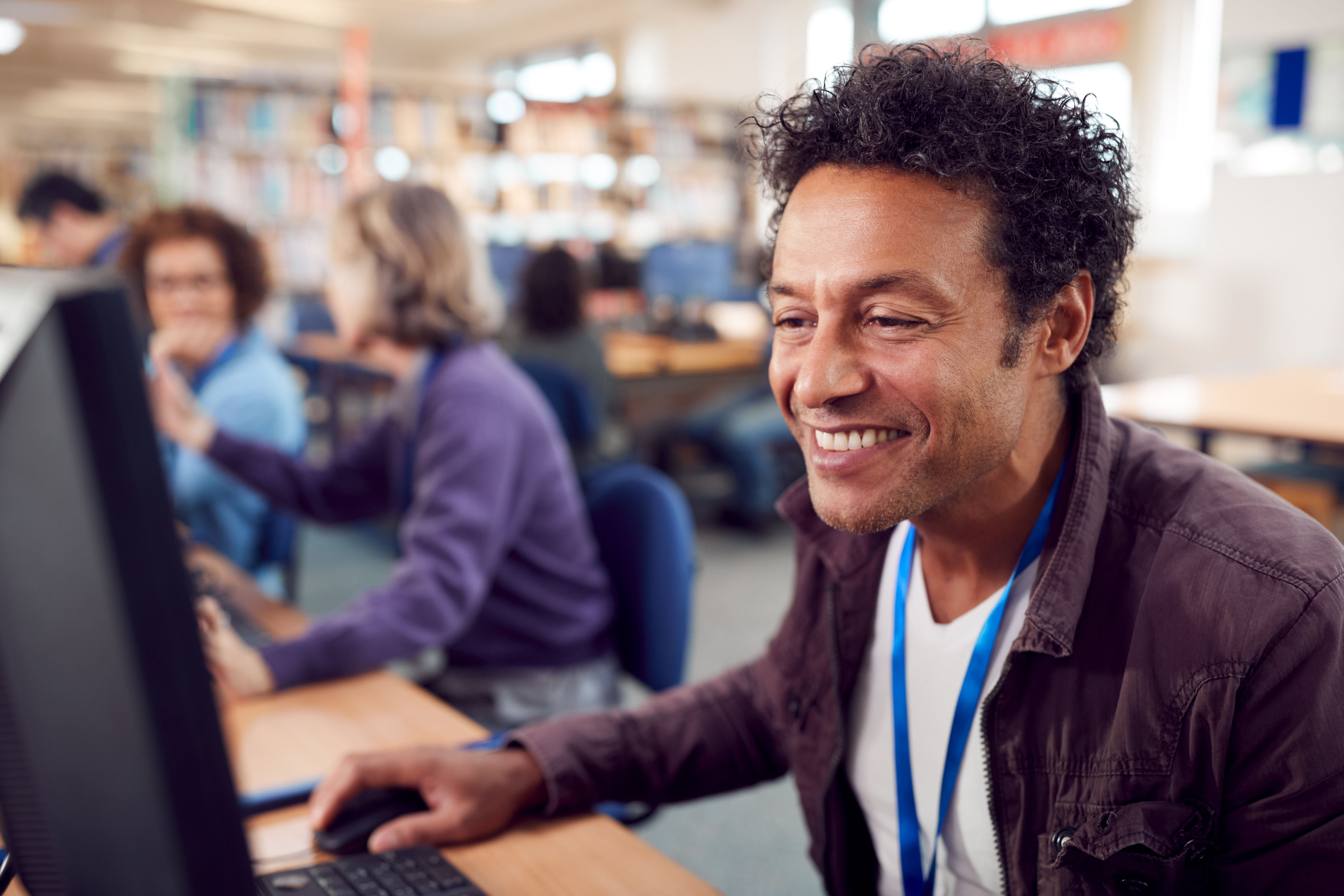 smiling employee working on computer in office