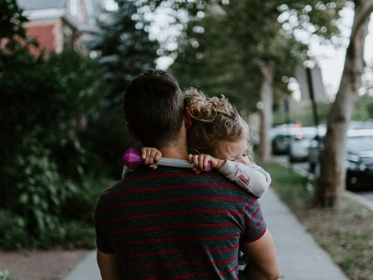 Father carrying daughter