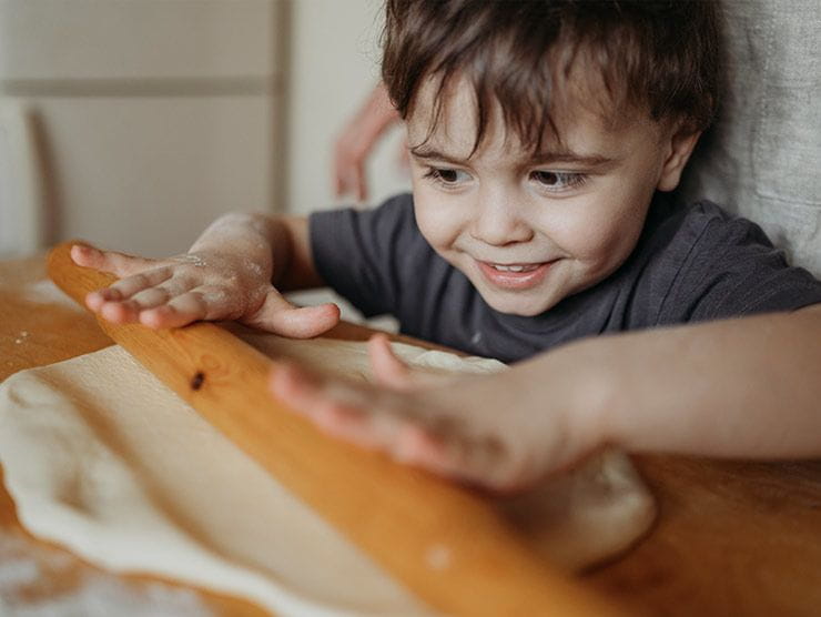 Toddler rolling dough