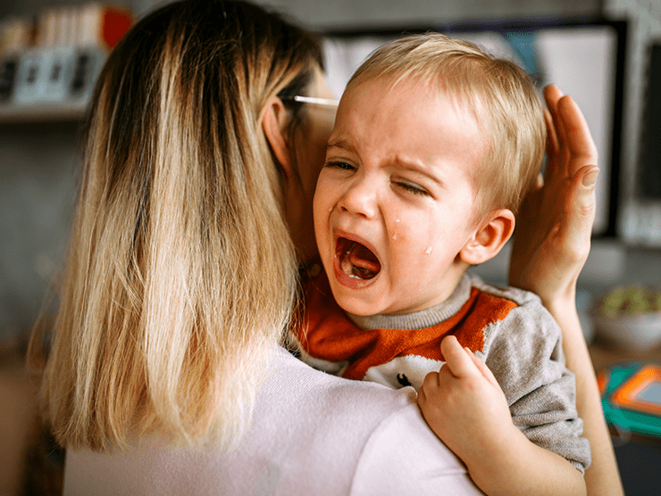 Child crying while being held