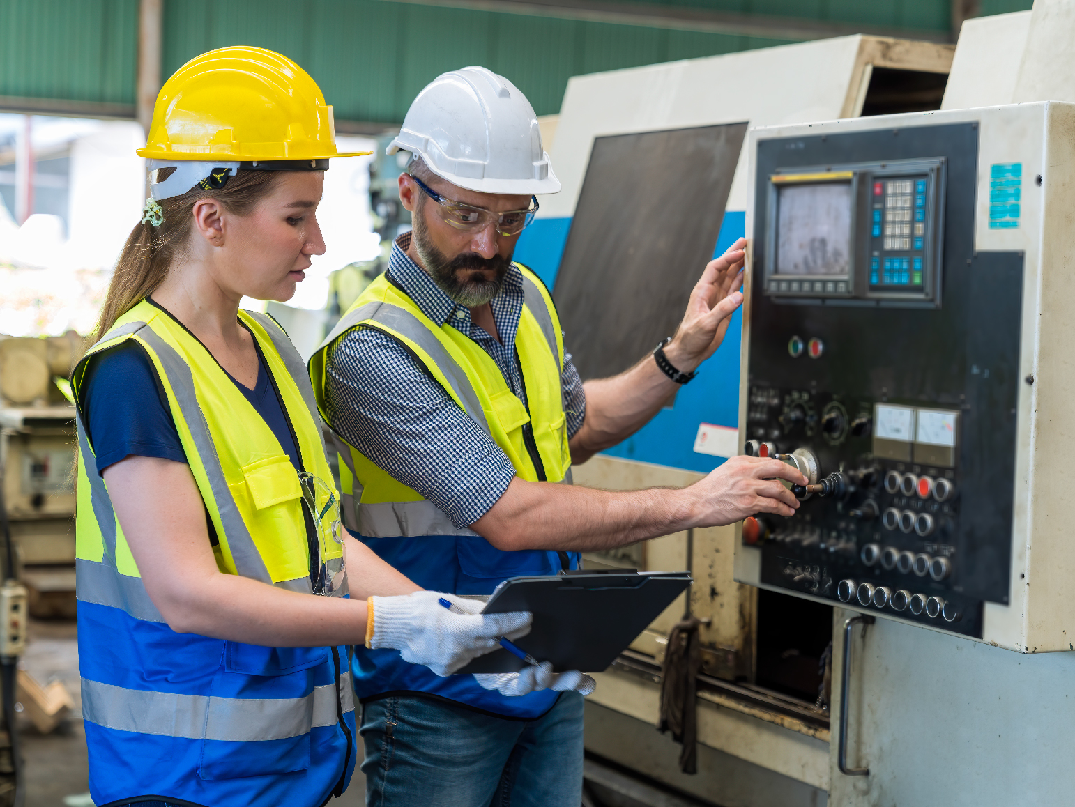 Frontline workers reviewing machinery