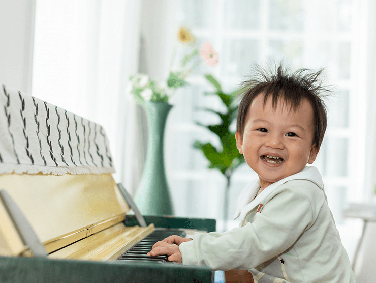 Toddler playing piano