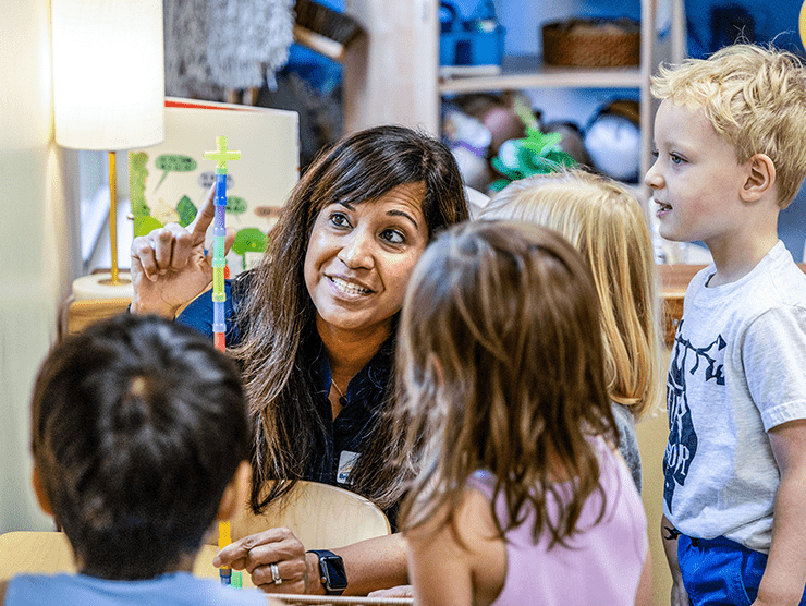 Teacher and a small group playing a game in a classroom