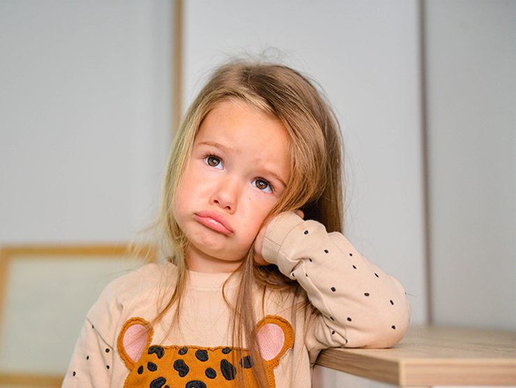 Young girl bored in kitchen