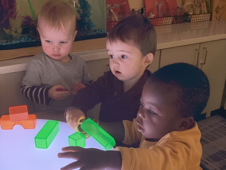 Three boys playing with toys