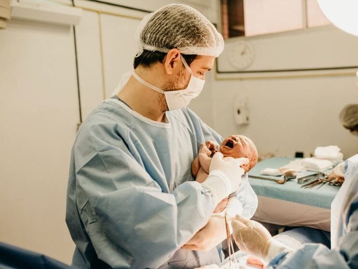 Doctor holding a newborn baby