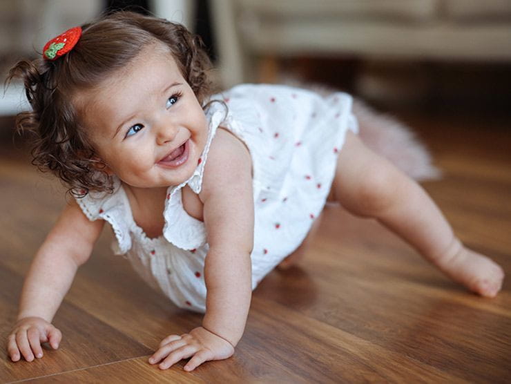 Girl toddler crawling on the floor