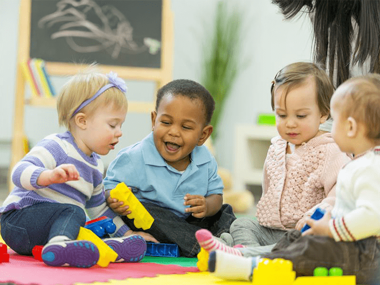 Toddlers playing with toys on the floor