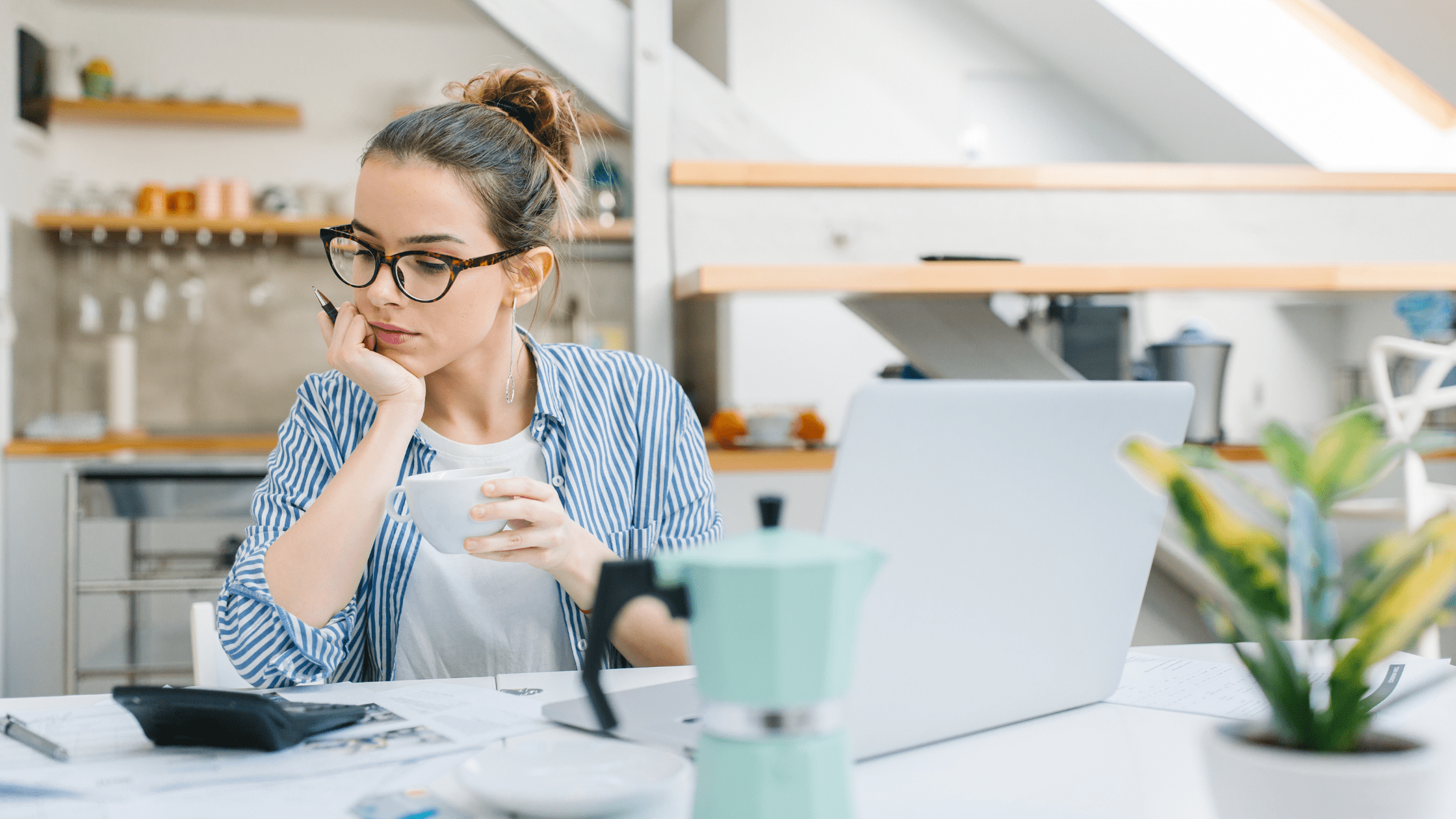 woman budgeting with laptop and calculator