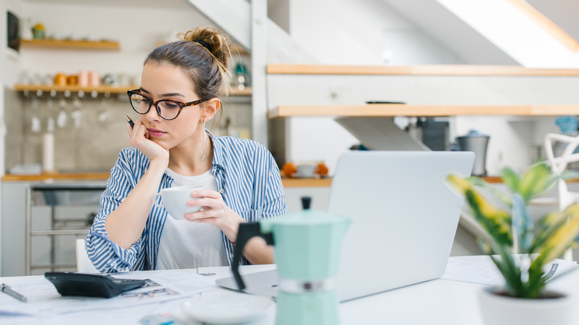 woman budgeting with laptop and calculator