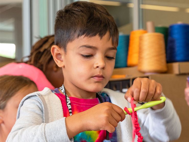 A boy crocheting.